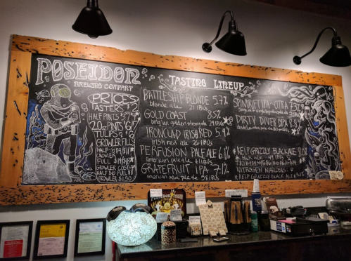 Chalkboard menu featuring Poseidon Brewing Company's beer lineup and prices, with artistic illustrations and details.