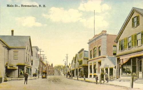 Historic postcard of Main Street in Newmarket, NH, featuring early 20th-century buildings and a vintage car.