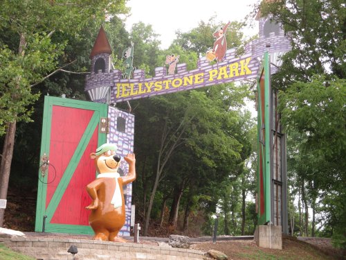 Entrance to Jellystone Park featuring a large statue of Yogi Bear and a colorful castle-like archway.