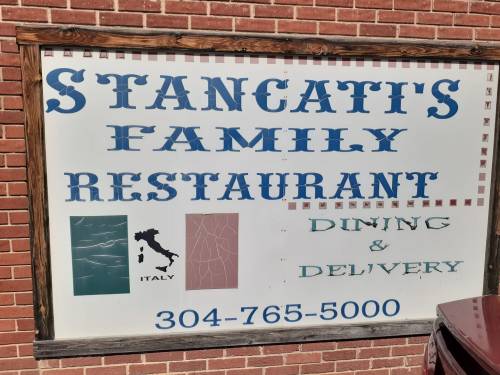 Sign for Stancati's Family Restaurant featuring "Dining & Delivery" and a graphic of Italy. Phone number: 304-765-5000.