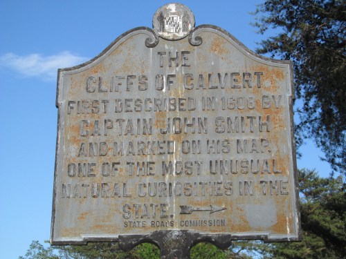 Weathered historical marker about the Cliffs of Calvert, first described by Captain John Smith in 1508.