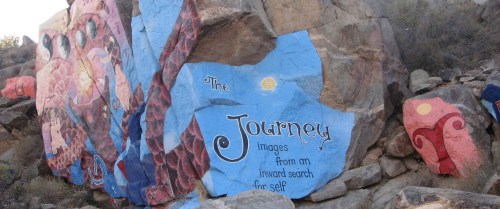 Colorful mural on a rocky surface featuring the text "The Journey: images from an inward search for self."