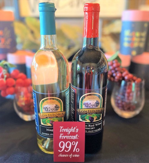 Two bottles of wine, one white and one red, with a sign reading "Tonight's Forecast: 99% chance of wine."