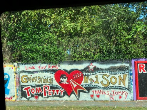 Mural honoring Tom Petty with hearts, stars, and the message "Love you always, Gainesville No. 1 Son. Thanks, Tommy."