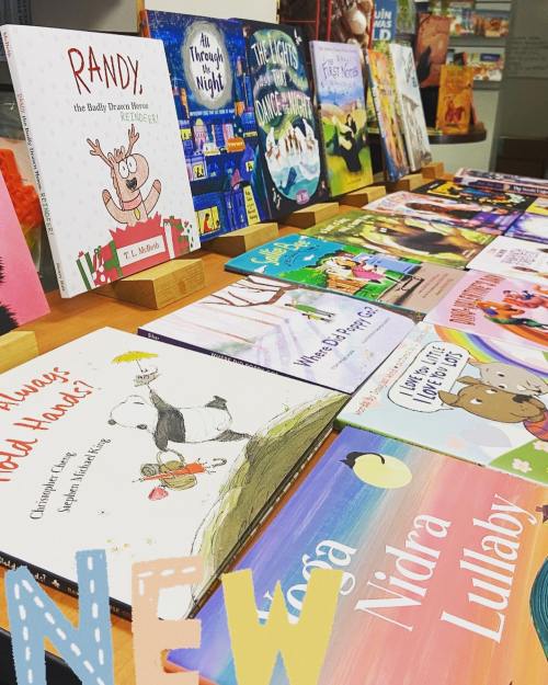 A colorful display of children's books on a table, featuring various titles and illustrations.