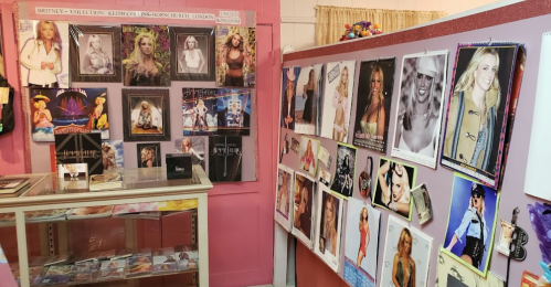 A colorful display featuring posters and memorabilia of various pop icons, including a dedicated section for Britney Spears.