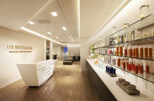 Interior of The Rittenhouse Spa, featuring a sleek reception area and shelves of colorful skincare products.