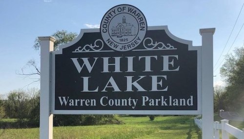 Sign for White Lake, Warren County Parkland, New Jersey, featuring the county seal and established date of 1825.