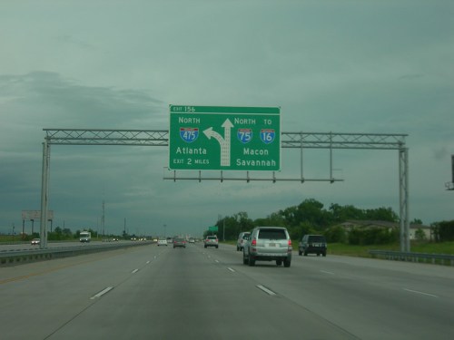 Highway sign indicating directions to Atlanta, Macon, and Savannah, with an exit for I-475 North.