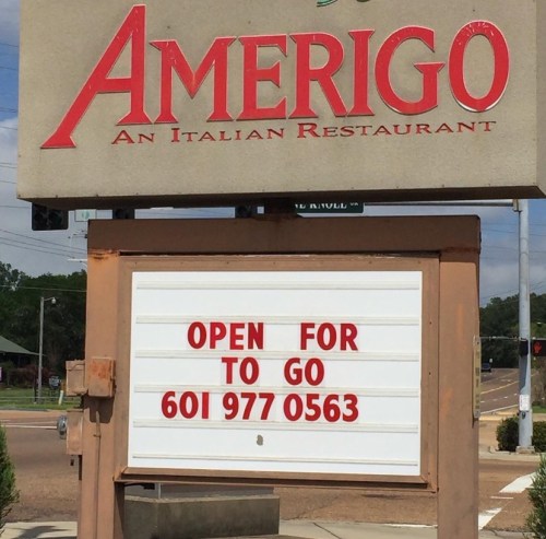 Sign for Amerigo Italian Restaurant, stating "Open for To Go" with phone number 601-977-0563.