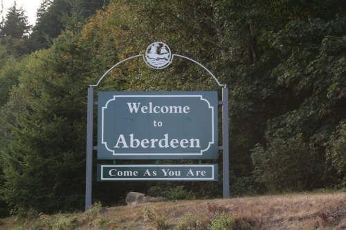 Welcome sign for Aberdeen, featuring the phrase "Come As You Are" against a backdrop of trees.