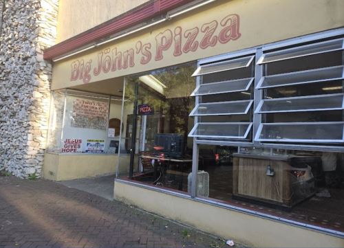 Exterior of Big John's Pizza, featuring large windows and a sign with the restaurant's name.