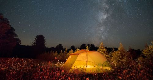 A lit tent unde the stars at Cherry Springs State Park in Coudersport, Pennsylvania
