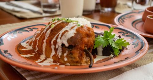 close up photo of Chile Relleno, a classic New Mexico dish, on a pink patterned plate in New Mexico