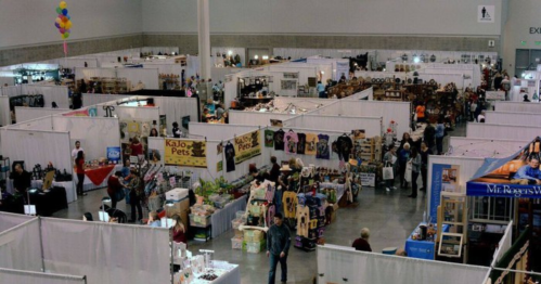 Aerial view of a bustling trade show with vendor booths and visitors exploring various products.