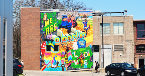 Colorful mural on a building in Oberlin, featuring the text "We Are Oberlin" and vibrant community imagery.
