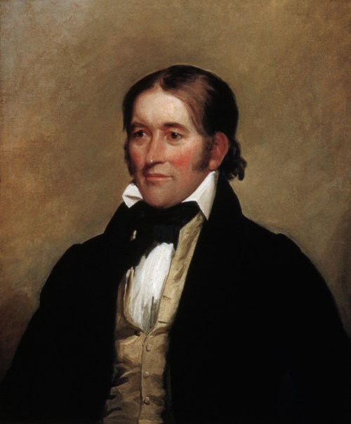 Portrait of a man in 19th-century attire, featuring a dark coat and a white cravat, with a neutral background.