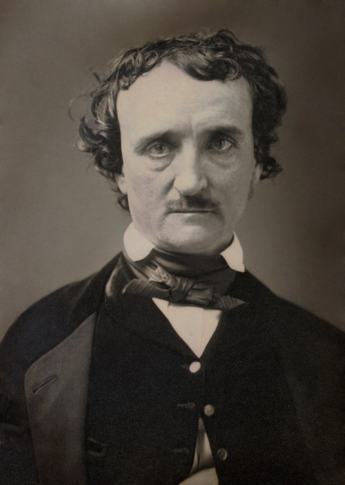 A historical portrait of a man with dark hair and a mustache, wearing a formal black coat and white shirt.