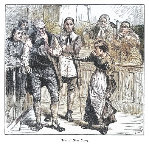 Illustration of the trial of Giles Corey, featuring a courtroom scene with several figures in 18th-century attire.