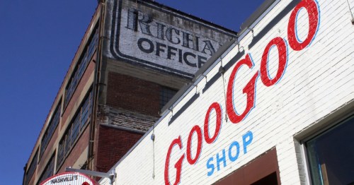 A building with a vintage "Richards Office" sign and a modern "Goo Goo Shop" storefront in Nashville.
