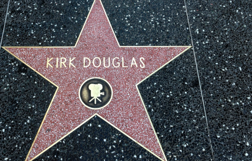 Star on the Hollywood Walk of Fame honoring Kirk Douglas, featuring his name and a film camera emblem.
