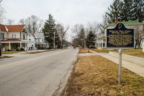 A quiet street in Danville, featuring historic homes and a sign marking the Main Street Historic District.