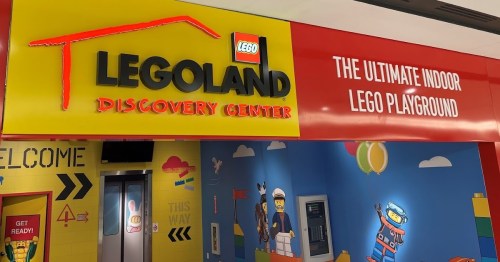 Brightly colored entrance to LEGOLAND Discovery Center, featuring the logo and text about an indoor LEGO playground.