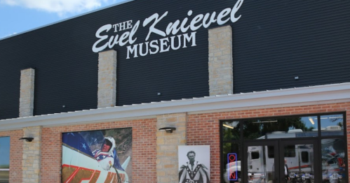 Exterior of the Evel Knievel Museum, featuring a large sign and promotional images of Evel Knievel.