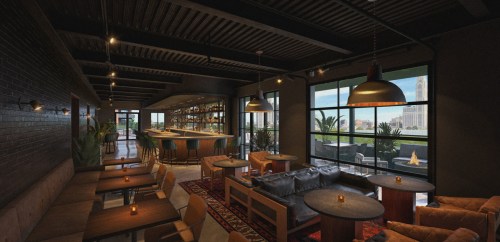 A modern lounge with wooden tables, cozy seating, and large windows showcasing a city view. Warm lighting creates a welcoming atmosphere.