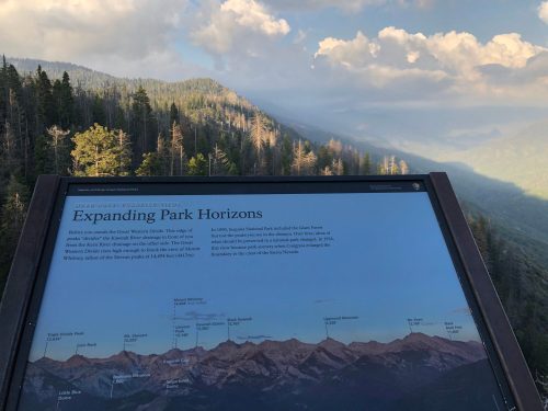 A scenic view of mountains with a sign titled "Expanding Park Horizons" detailing park features and landmarks.