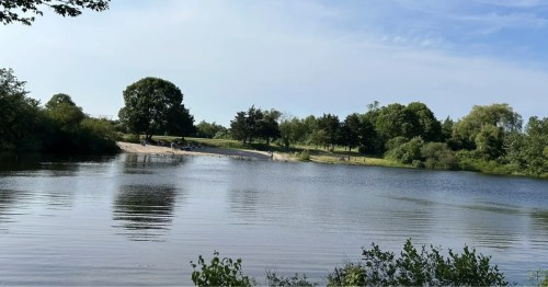 People enjoying the beach at Ninigret Pond in Rhode Island.