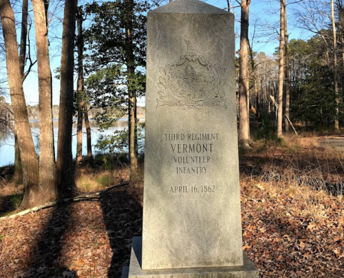 A stone monument honoring the Third Regiment Vermont Volunteer Infantry, dated April 16, 1862, surrounded by trees.