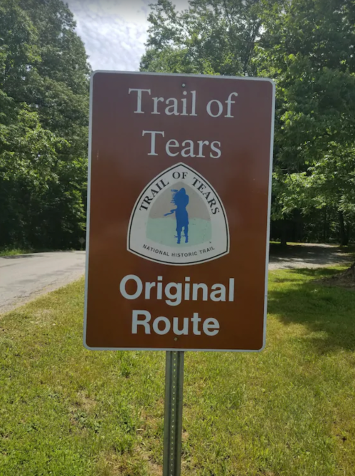 Sign for the Trail of Tears, indicating the original route of this National Historic Trail, surrounded by greenery.