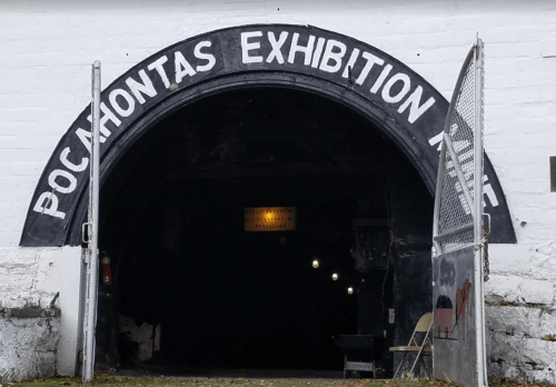 Entrance to the Pocahontas Exhibition Mine, featuring a large arched sign and a dark tunnel beyond.