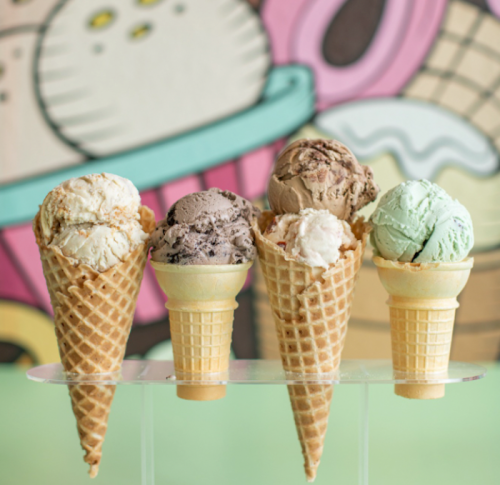 Five ice cream cones with various flavors, displayed against a colorful, whimsical background.