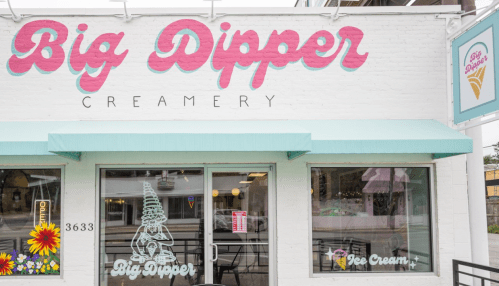 Exterior of Big Dipper Creamery featuring colorful signage, a pastel awning, and a welcoming atmosphere.