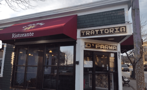 Exterior of Trattoria D'Parma restaurant, featuring a red awning and wooden signage, set in a quaint neighborhood.