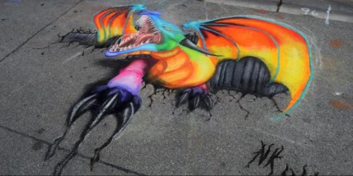 Colorful 3D chalk art of a dragon emerging from cracked pavement, featuring vibrant scales and sharp claws.