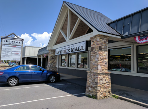 Exterior view of the Clearview Antique Mall, featuring a stone facade and a blue car parked in front.
