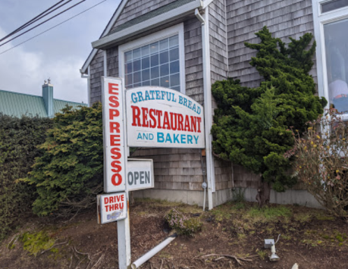 Sign for Grateful Bread Restaurant and Bakery, featuring "Espresso" and "Drive Thru" with an "Open" indication.