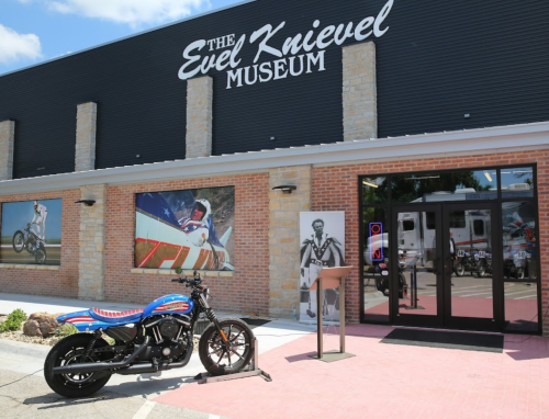 Exterior of the Evel Knievel Museum featuring a motorcycle and large images of Knievel on the walls.