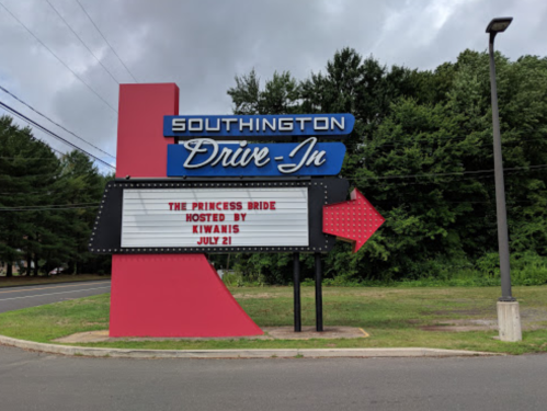 Sign for Southington Drive-In featuring "The Princess Bride" hosted by Kiwanis on July 21, surrounded by trees.