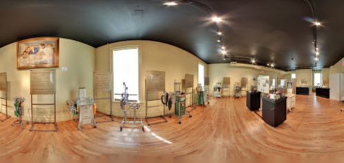 A panoramic view of a museum exhibit featuring historical medical equipment and informative displays.