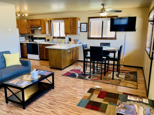 Cozy living space featuring a kitchen, dining area, and comfortable seating with modern decor and wooden accents.