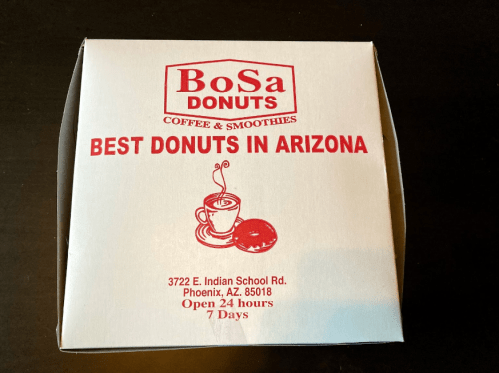 White donut box with red text, "Bosa Donuts," and "Best Donuts in Arizona," featuring a coffee cup and donut graphic.