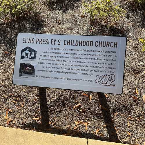 Sign about Elvis Presley’s childhood church, detailing its history and significance in his early musical influences.