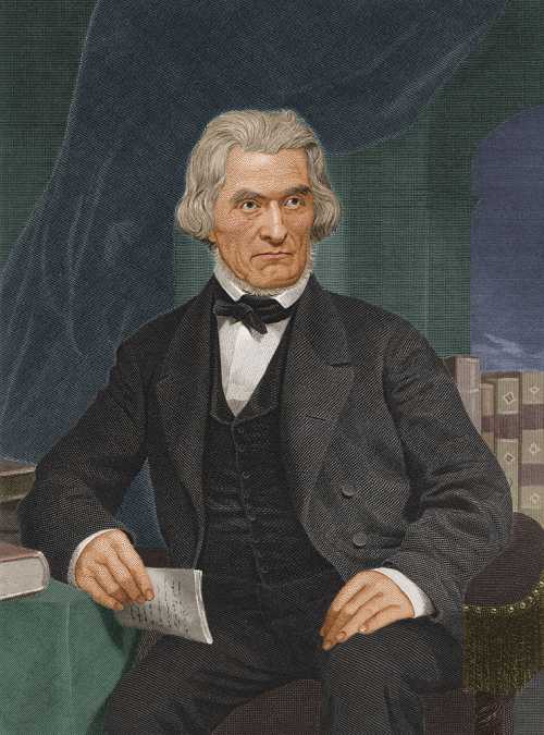 A historical portrait of a man with gray hair, dressed in a black suit, seated with a paper in hand.