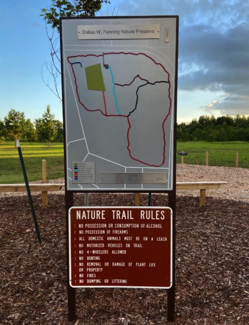 Map of Dallas W. Fanning Nature Preserve with trail rules displayed below, surrounded by greenery and blue sky.