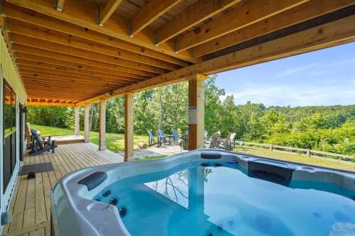 A hot tub on a wooden deck with a scenic view of greenery and outdoor seating in the background.