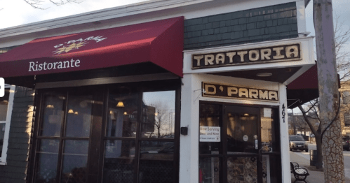 Exterior of Trattoria D'Parma restaurant, featuring a red awning and a sign with the restaurant's name.
